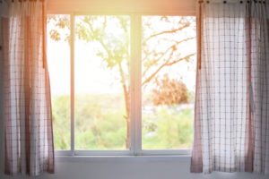 Sliding replacement window looking out on a sunrise