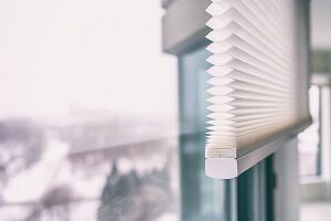 Zoom-in shot of white cellular shades emphasizing their pleats 