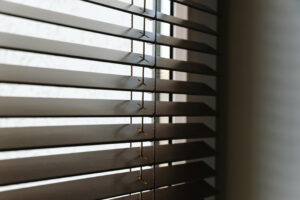 Wooden blinds on the window in the living room.