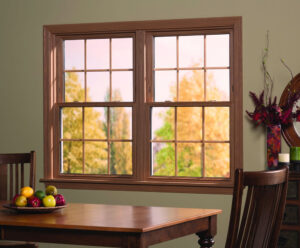 A pair of side-by-side double-hung windows in a dining room looking out on fall foliage